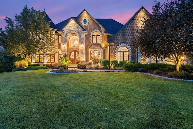 tudor-style house featuring a lawn