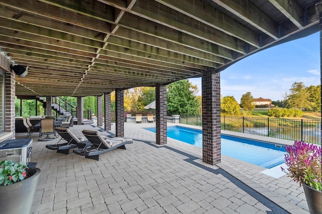 view of patio with a water view and a fenced in pool