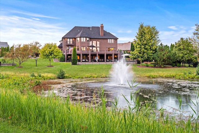 rear view of house featuring a water view