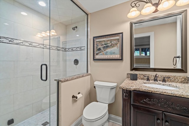 bathroom featuring vanity, toilet, and an enclosed shower