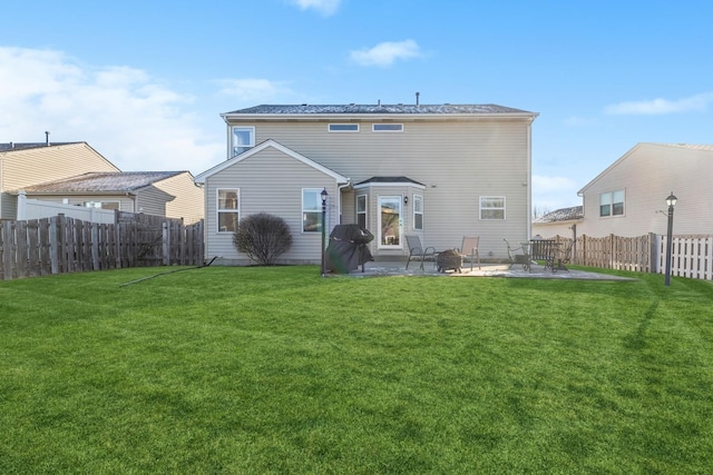 back of property featuring a lawn and a patio area