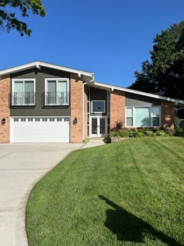 view of front of property with a garage and a front yard