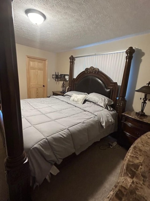 bedroom featuring carpet flooring and a textured ceiling