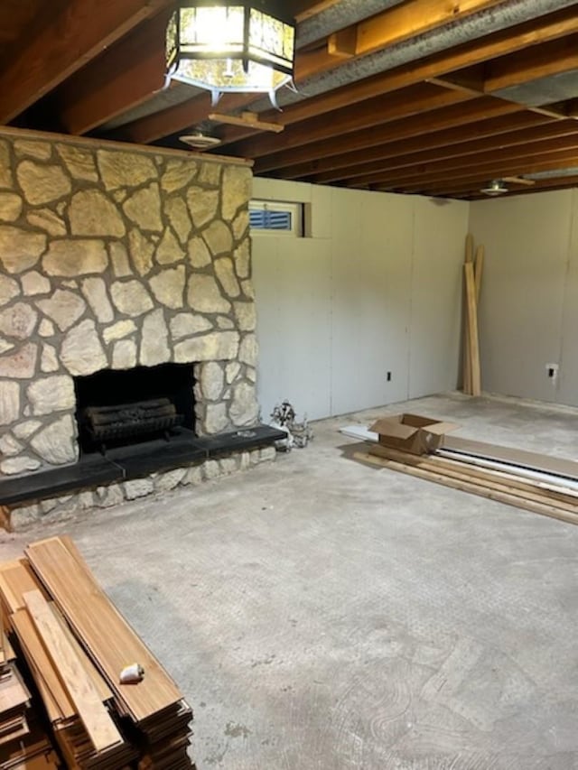 unfurnished living room featuring a fireplace and concrete floors