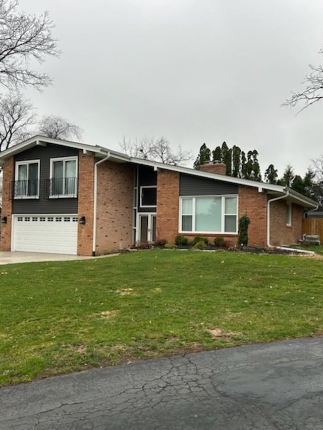 view of front facade with a front yard and a garage