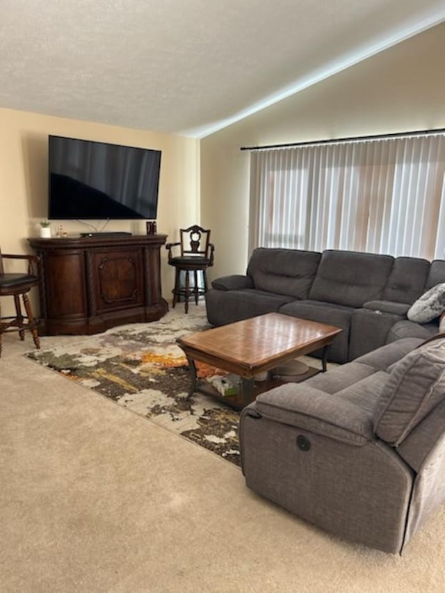 carpeted living room with vaulted ceiling