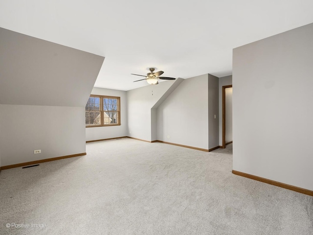 bonus room featuring light colored carpet, vaulted ceiling, and ceiling fan