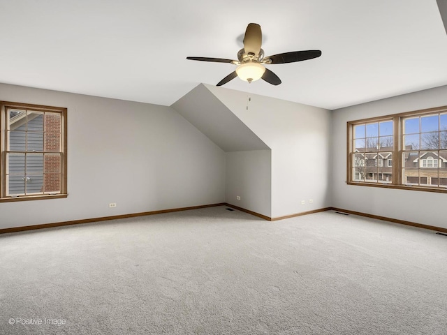 additional living space featuring carpet, ceiling fan, and vaulted ceiling