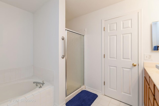 bathroom featuring tile patterned floors, vanity, and separate shower and tub