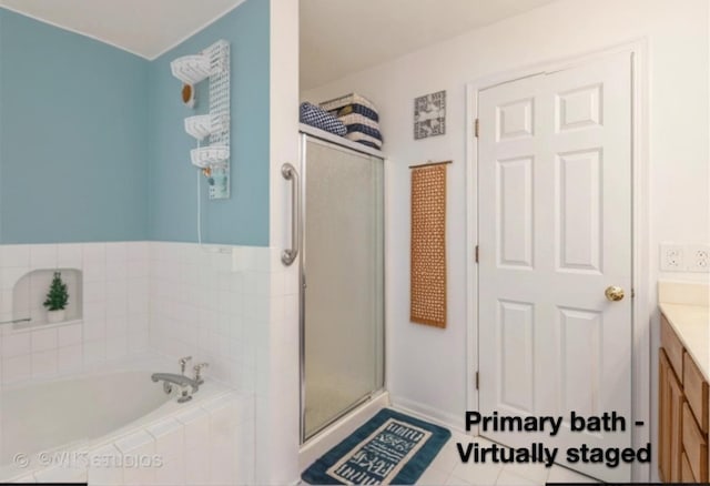 bathroom with tile patterned floors, vanity, and independent shower and bath