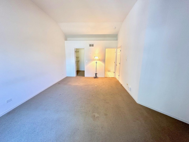 empty room with carpet, visible vents, and baseboards