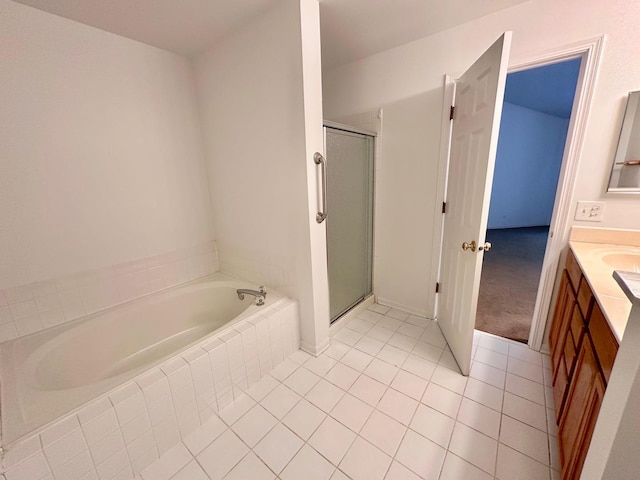 bathroom featuring a bath, a stall shower, vanity, and tile patterned floors