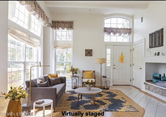 living room featuring light tile patterned floors and a towering ceiling