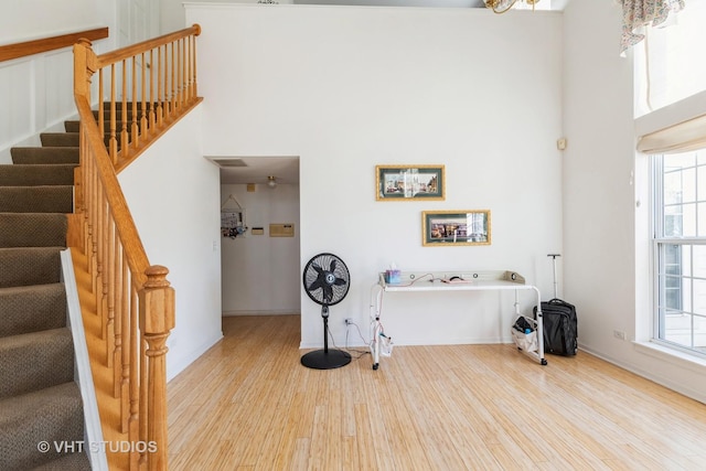 foyer entrance with hardwood / wood-style flooring and a high ceiling