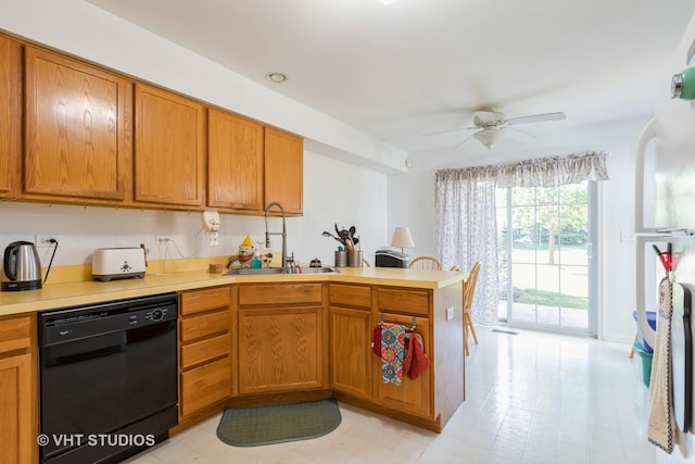 kitchen with kitchen peninsula, ceiling fan, sink, and black dishwasher