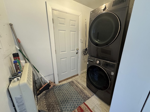 laundry area featuring stacked washer / drying machine