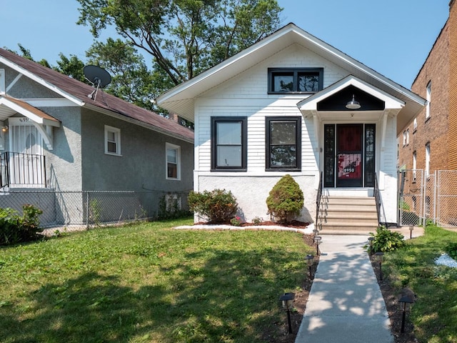 bungalow-style home featuring a front yard