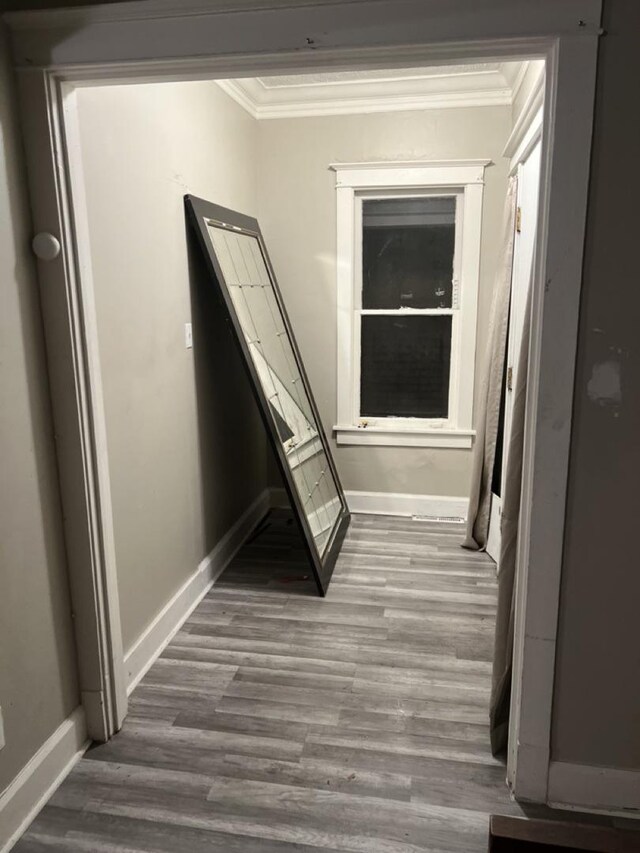 corridor with dark hardwood / wood-style floors and crown molding