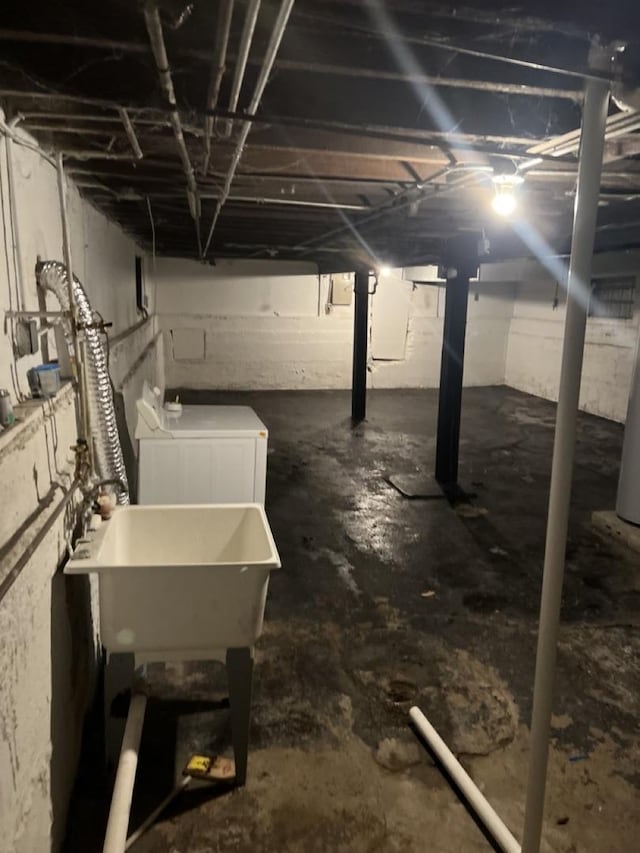 basement featuring washer / dryer and sink