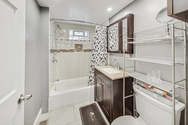 full bathroom featuring tile patterned flooring, vanity, toilet, and shower / bath combo with shower curtain