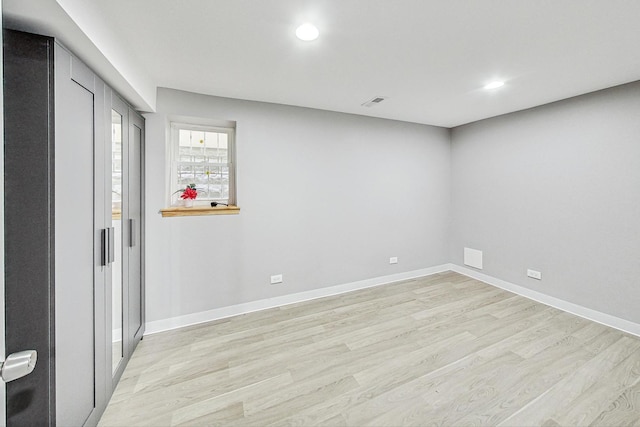 spare room featuring light hardwood / wood-style flooring