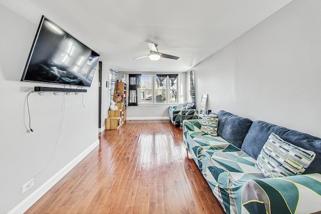 living room featuring ceiling fan and wood-type flooring