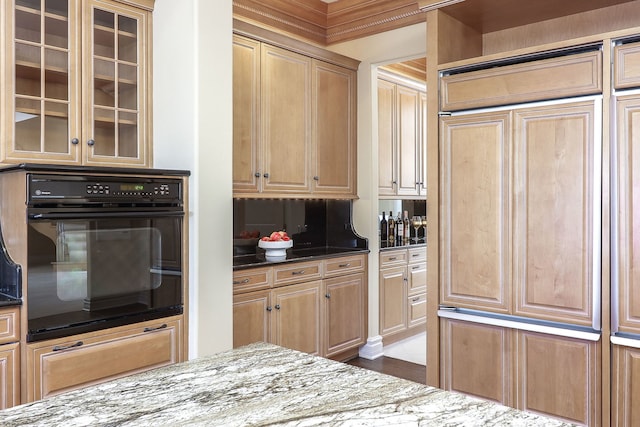 kitchen with dark stone counters, tasteful backsplash, and oven