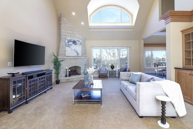 carpeted living room with high vaulted ceiling and a stone fireplace