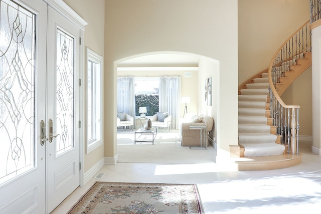 tiled foyer entrance featuring french doors