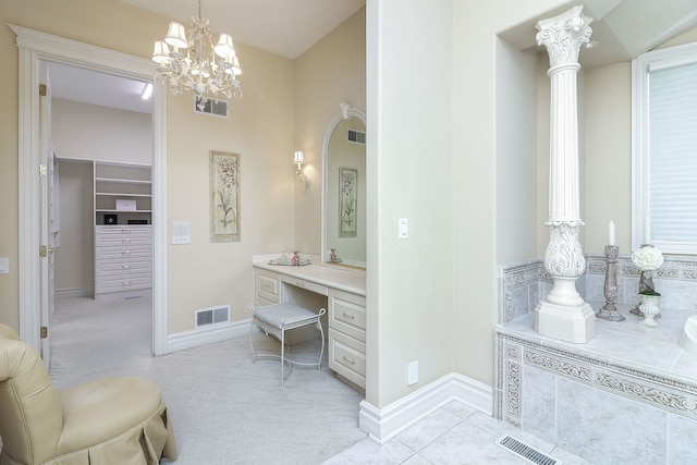 bathroom featuring tile patterned flooring and an inviting chandelier