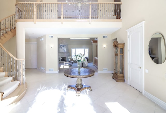 entryway with a high ceiling and a notable chandelier