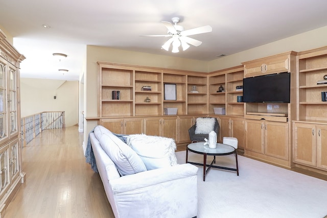 living room featuring light wood-type flooring and ceiling fan