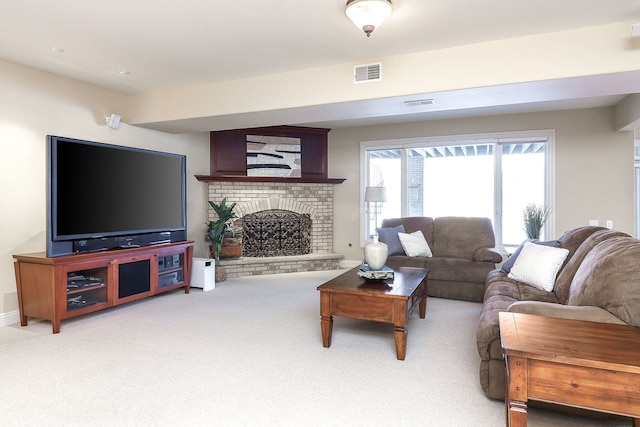 carpeted living room with a brick fireplace