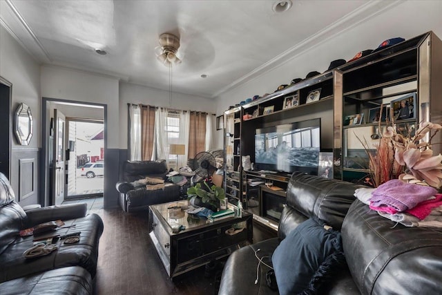 living room with a fireplace, dark hardwood / wood-style flooring, ceiling fan, and crown molding