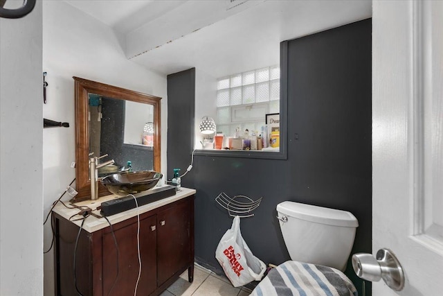 bathroom with tile patterned flooring, vanity, and toilet