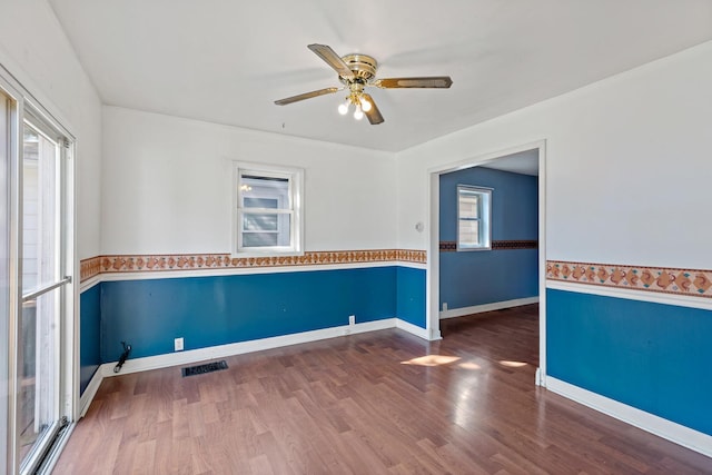 empty room featuring wood-type flooring and ceiling fan