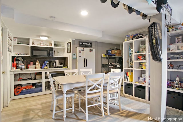 dining space with light hardwood / wood-style floors