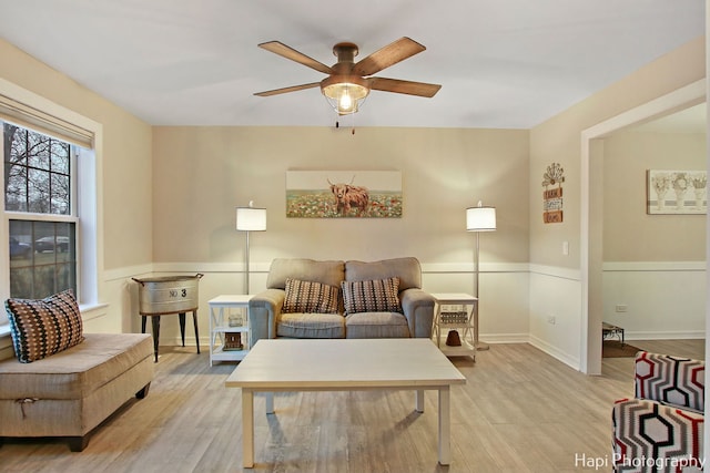 living room featuring ceiling fan and light hardwood / wood-style flooring