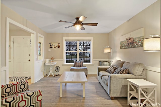 living room featuring hardwood / wood-style flooring and ceiling fan