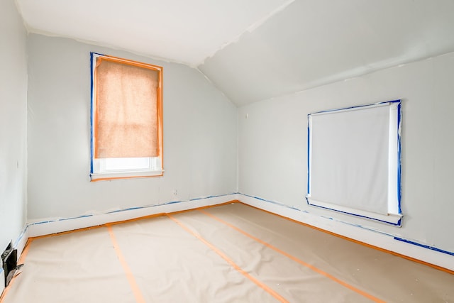 bonus room with baseboard heating and lofted ceiling