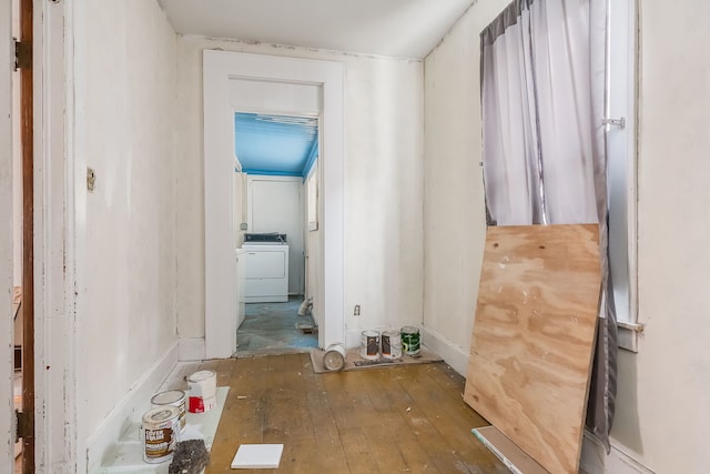 corridor featuring washer / dryer and hardwood / wood-style flooring