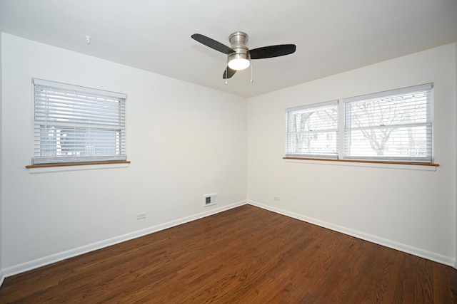 empty room with dark hardwood / wood-style flooring and ceiling fan