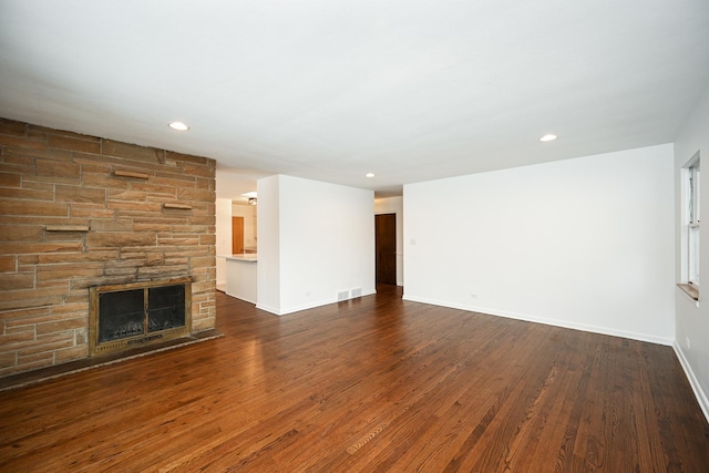 unfurnished living room featuring dark hardwood / wood-style flooring and a fireplace