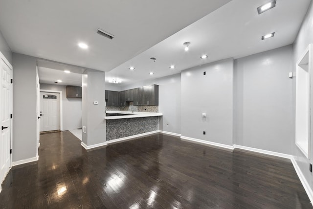 unfurnished living room with dark wood-type flooring