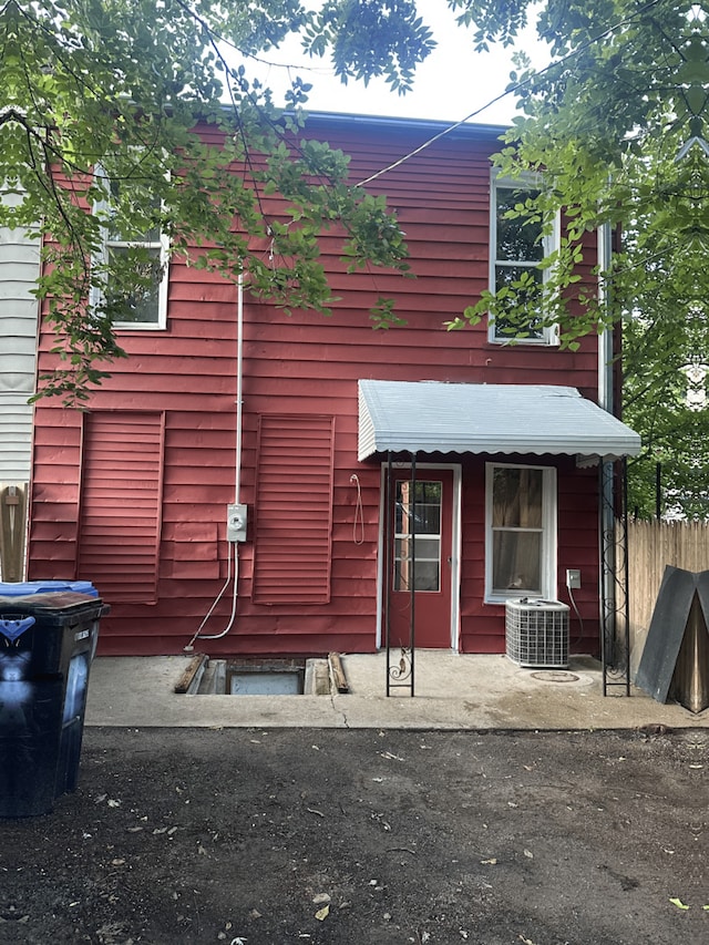 view of side of home with central AC unit