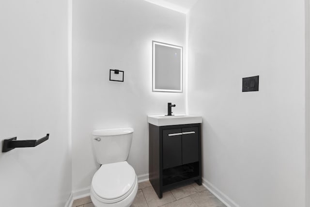 bathroom featuring tile patterned flooring, vanity, and toilet