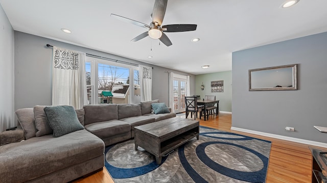 living room with hardwood / wood-style floors and ceiling fan