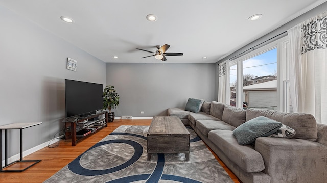 living room with hardwood / wood-style flooring and ceiling fan