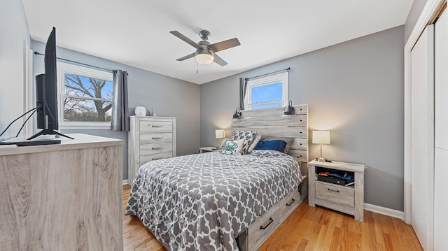 bedroom with a closet, ceiling fan, and light hardwood / wood-style flooring