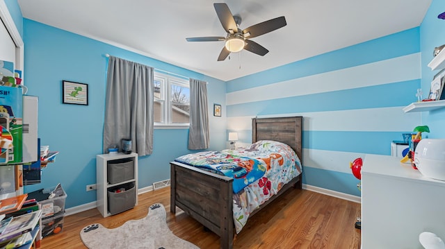 bedroom featuring hardwood / wood-style flooring and ceiling fan